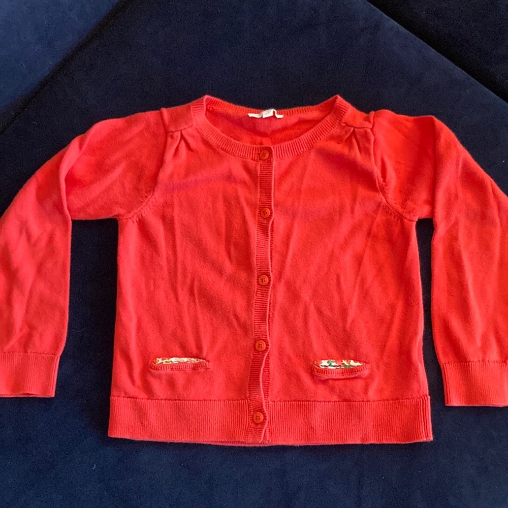 Navarro red cardigan sweater with puff sleeves and floral lines pockets